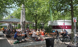 Guests can dine and socialize in a shaded outdoor area with comfortable seating.