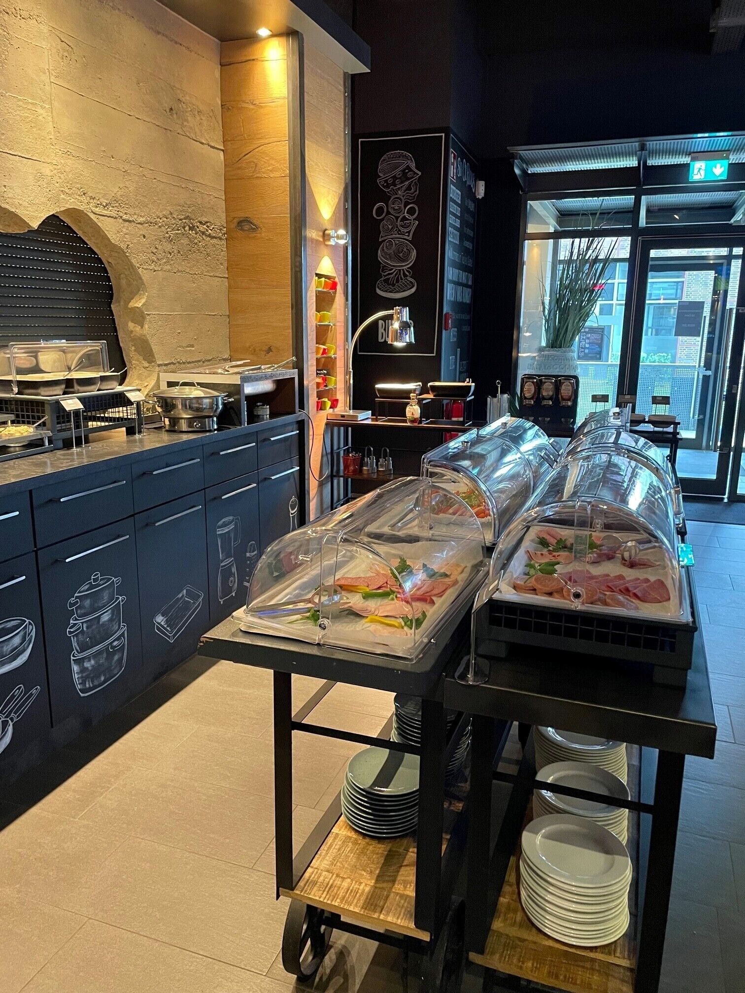 A buffet setup with covered food stations and a kitchen area with appliances.