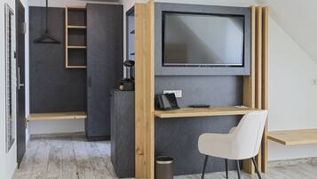 A modern, compact bedroom with a built-in desk, a television, and a hanging light fixture.