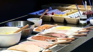A buffet with various meats and condiments.