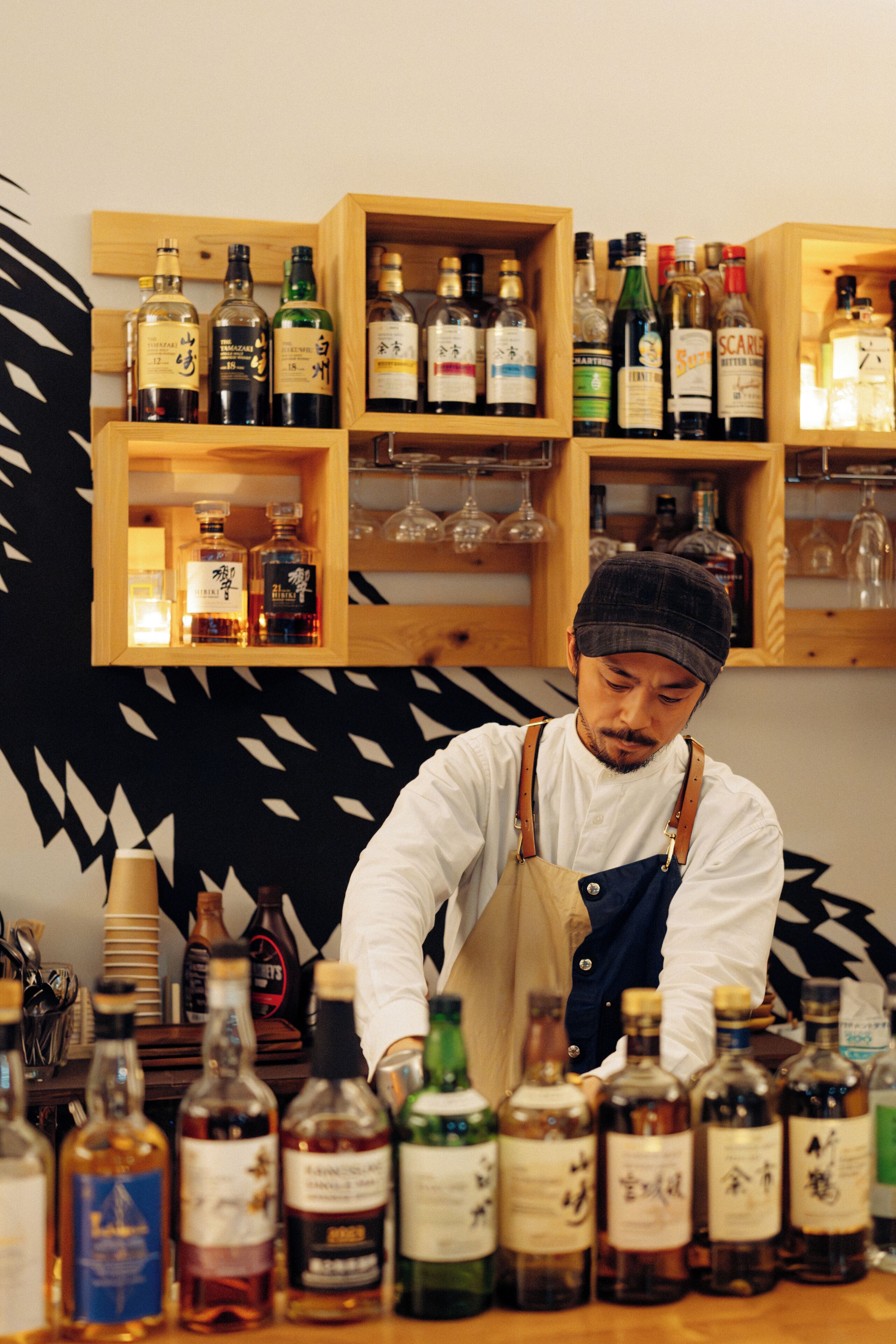A bar area with shelves of liquor bottles and glasses.