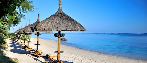 På stranden, solstolar, parasoller och strandhanddukar