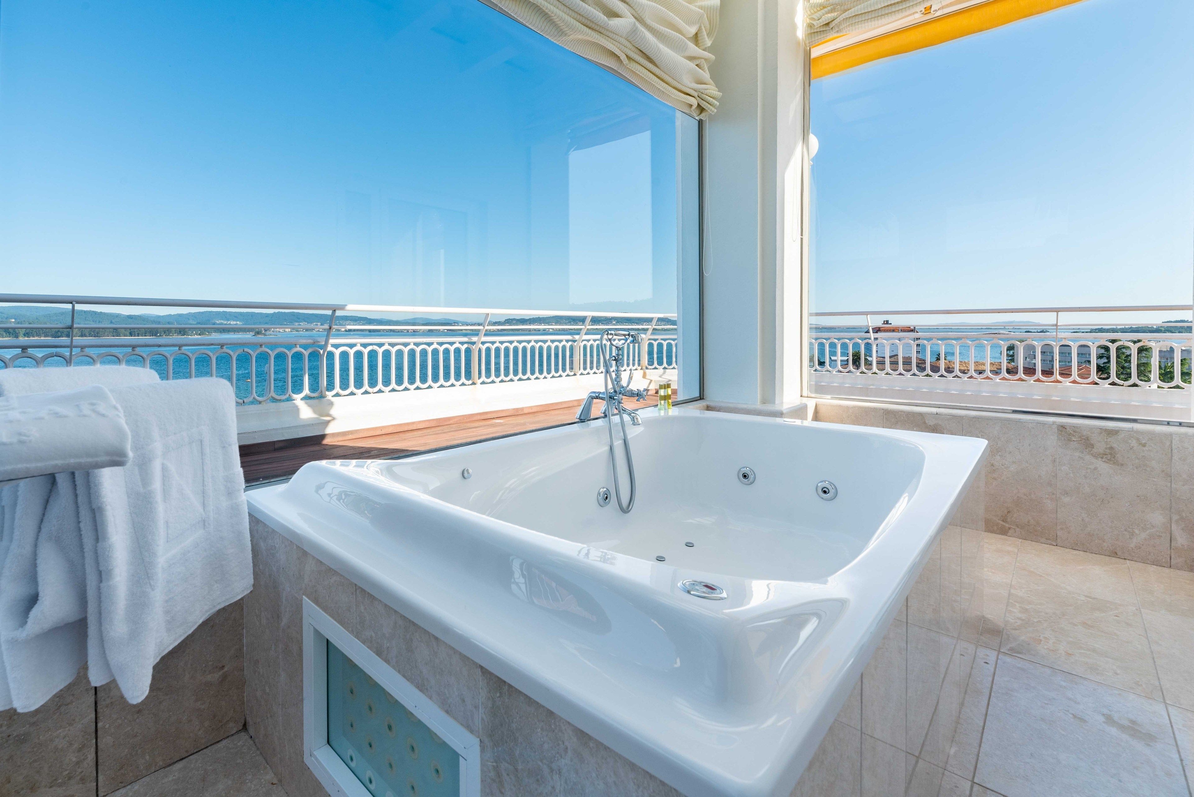 bathtub, designer toiletries, hair dryer, bathrobes