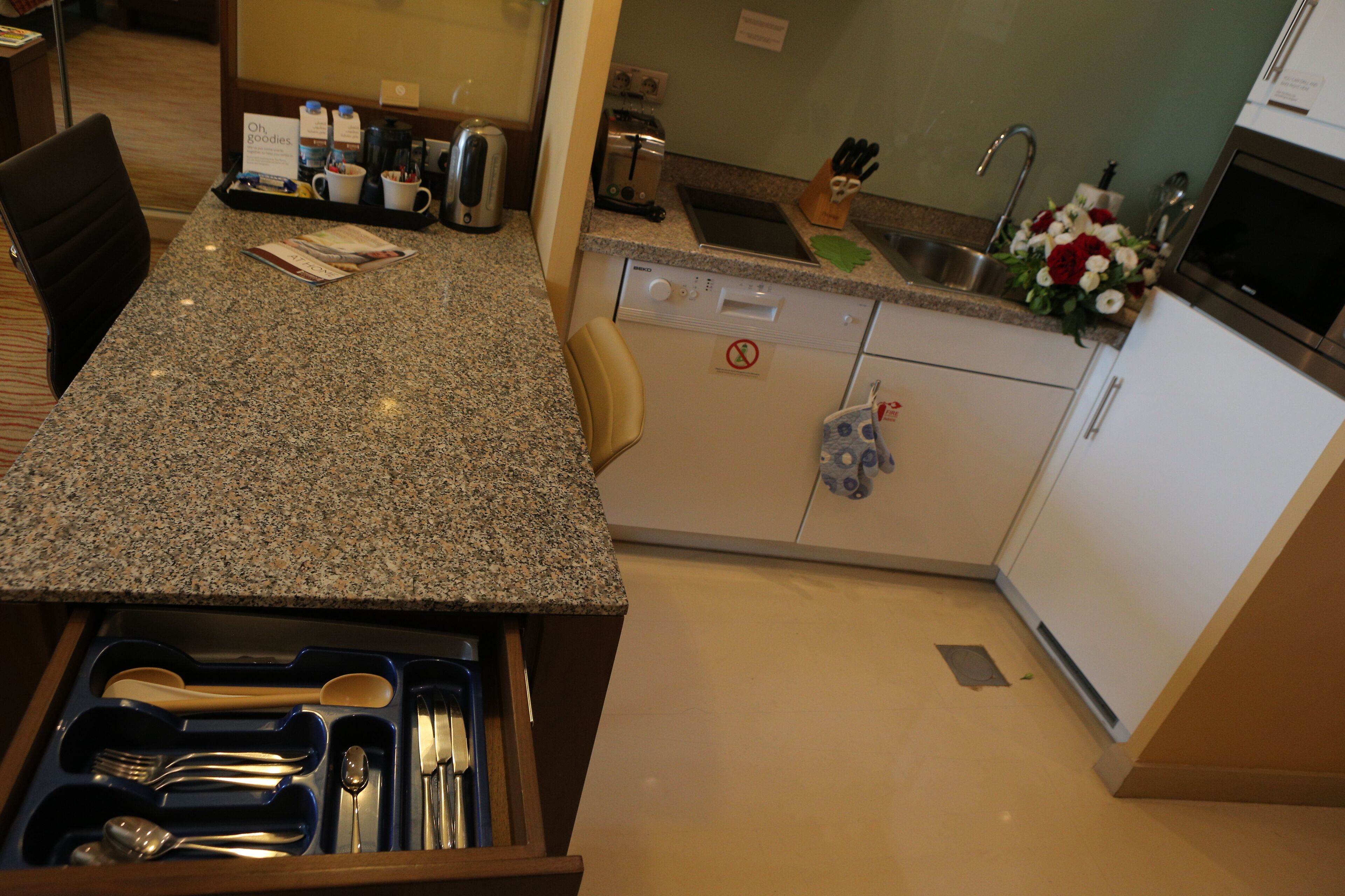 A kitchen with granite countertops, a dishwasher, and a sink.