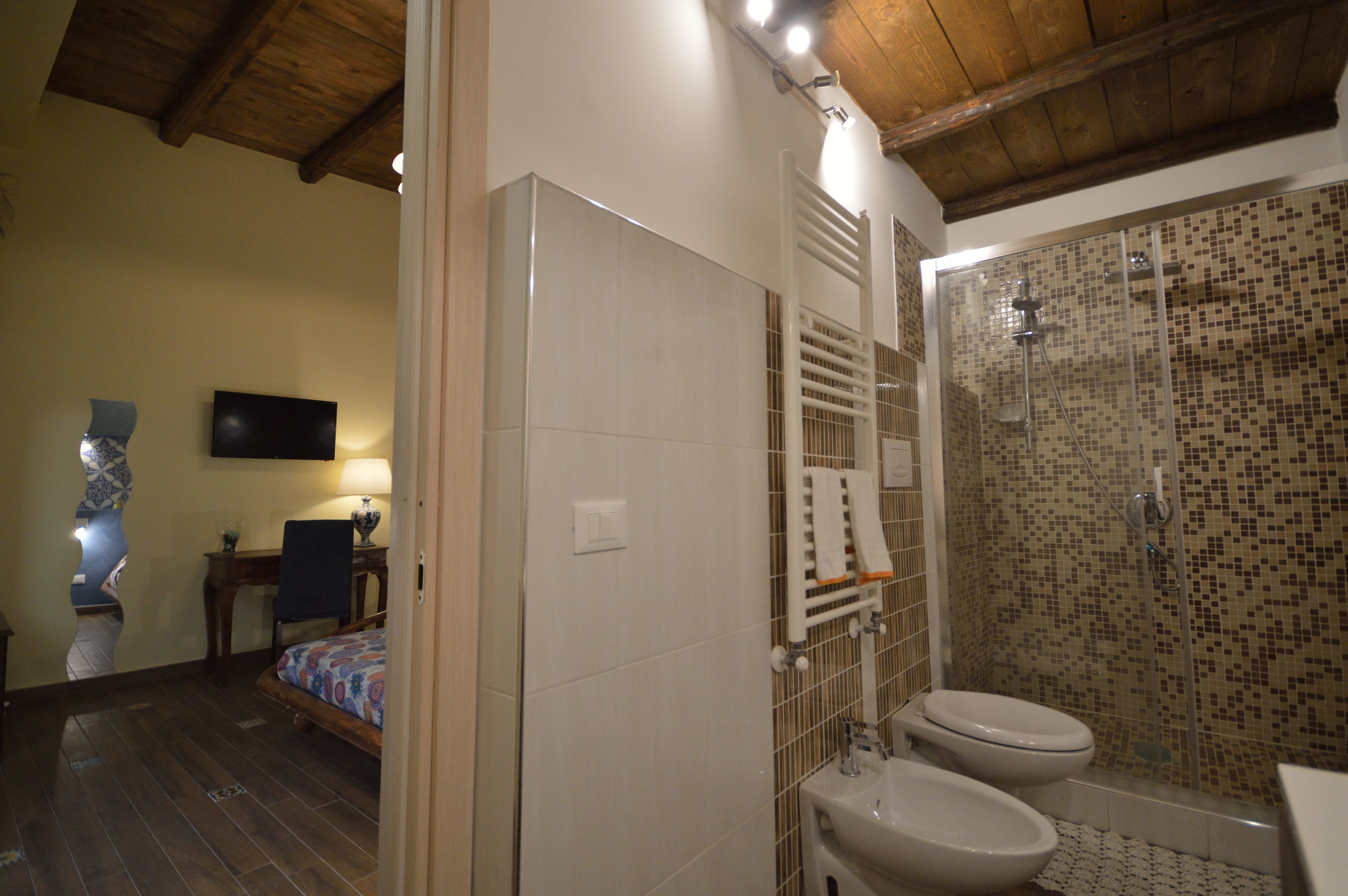 A bathroom with a shower, toilet, and sink.