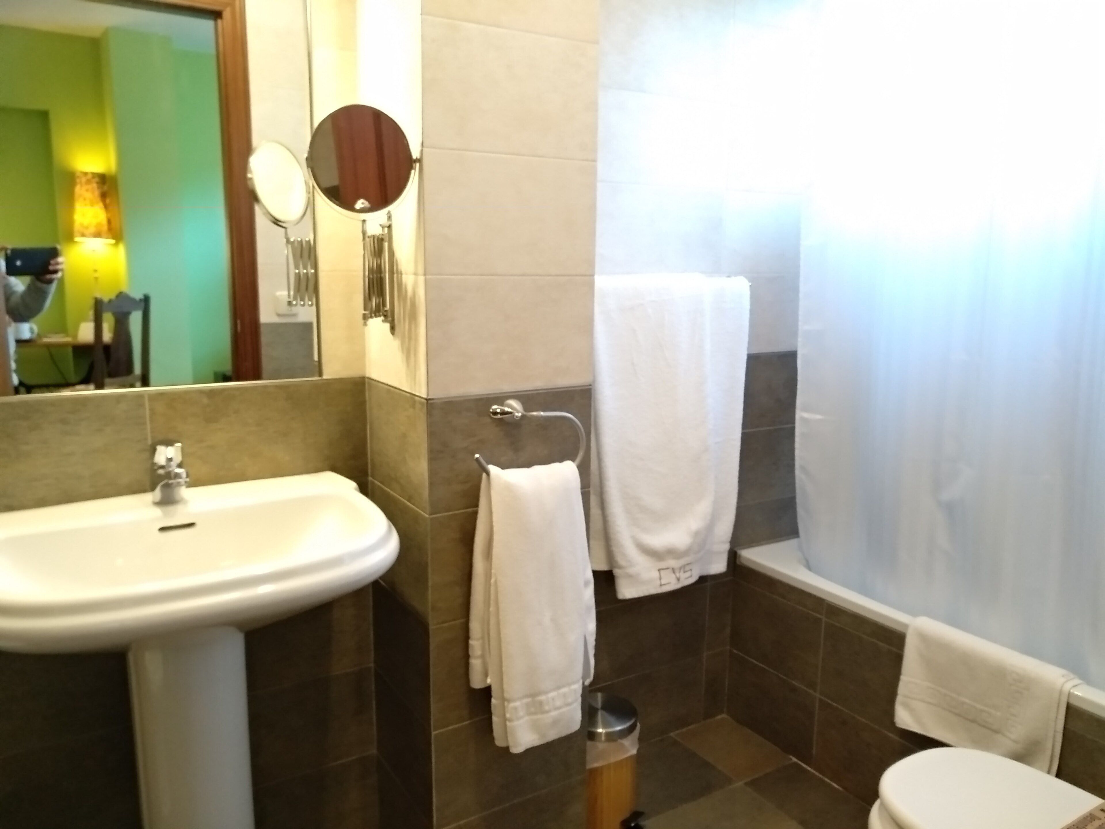 room with living room | bathroom | bathtub, free toiletries, hair dryer, towels