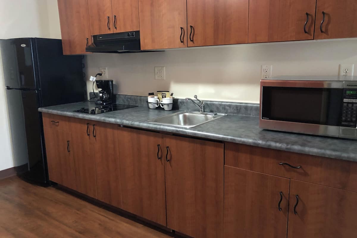 full-sized fridge, microwave, stovetop, coffee/tea maker