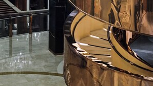 A modern interior with a spiral staircase and reflective surfaces. - The Azure Ningbo, Vignette Collection by IHG (Ningbo)