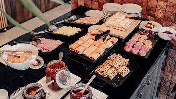 A buffet with various food items and condiments.