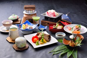 A variety of Japanese dishes and utensils on a table. - Kokonoe Yuyutei (Kokonoe)