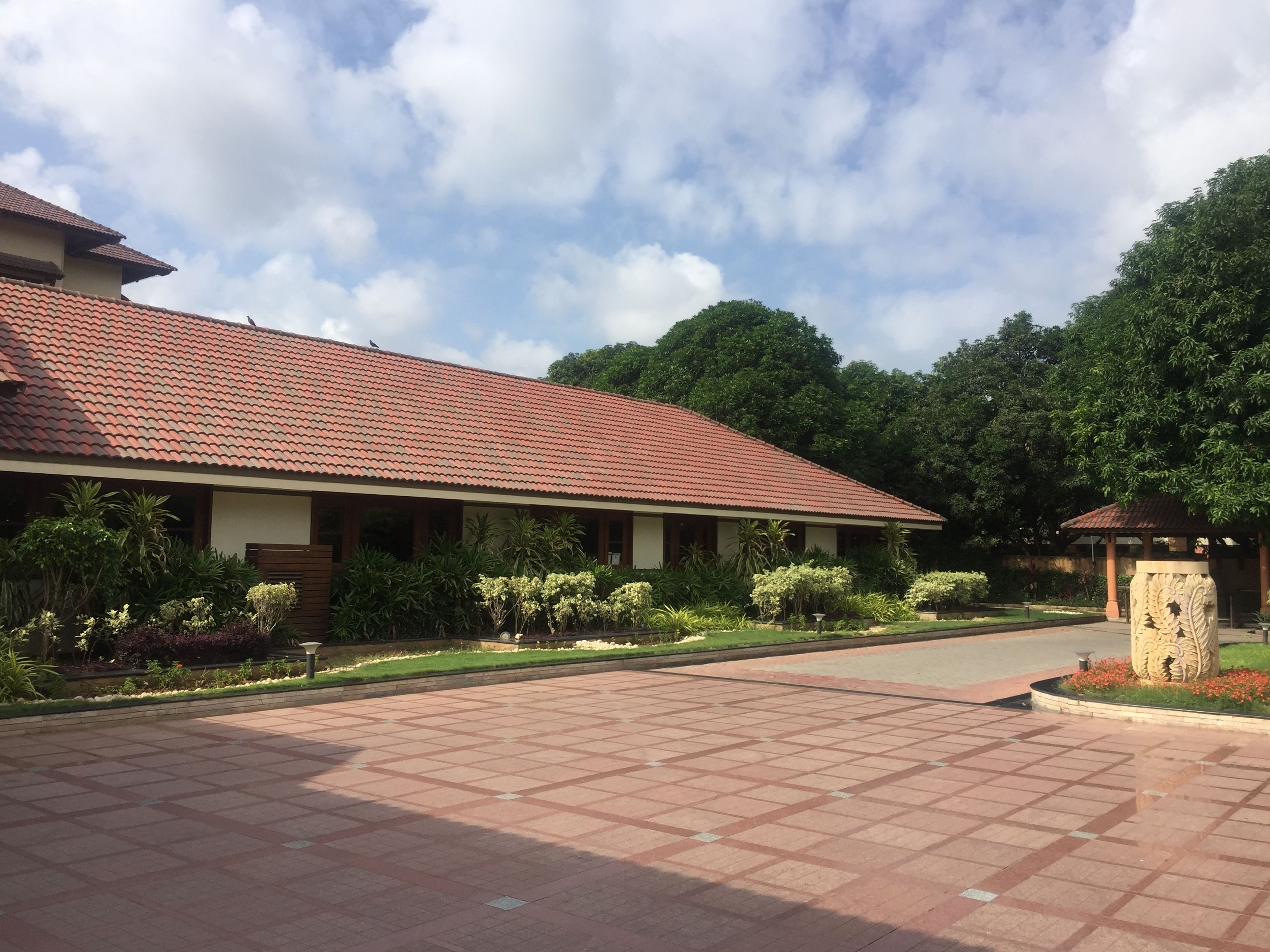 A building with a tiled roof and a paved courtyard.