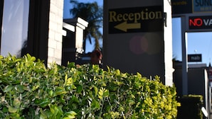 A reception area with a sign indicating the direction to the reception.