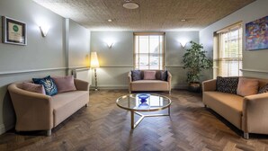 A living room with two sofas, a coffee table, a lamp, and a potted plant. - The Monterey Hotel, BW Signature Collection (St. Saviour)