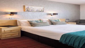 A hotel room with a large bed, two bedside tables, a nightstand, a desk, and a chair. - The Monterey Hotel, BW Signature Collection (St. Saviour)