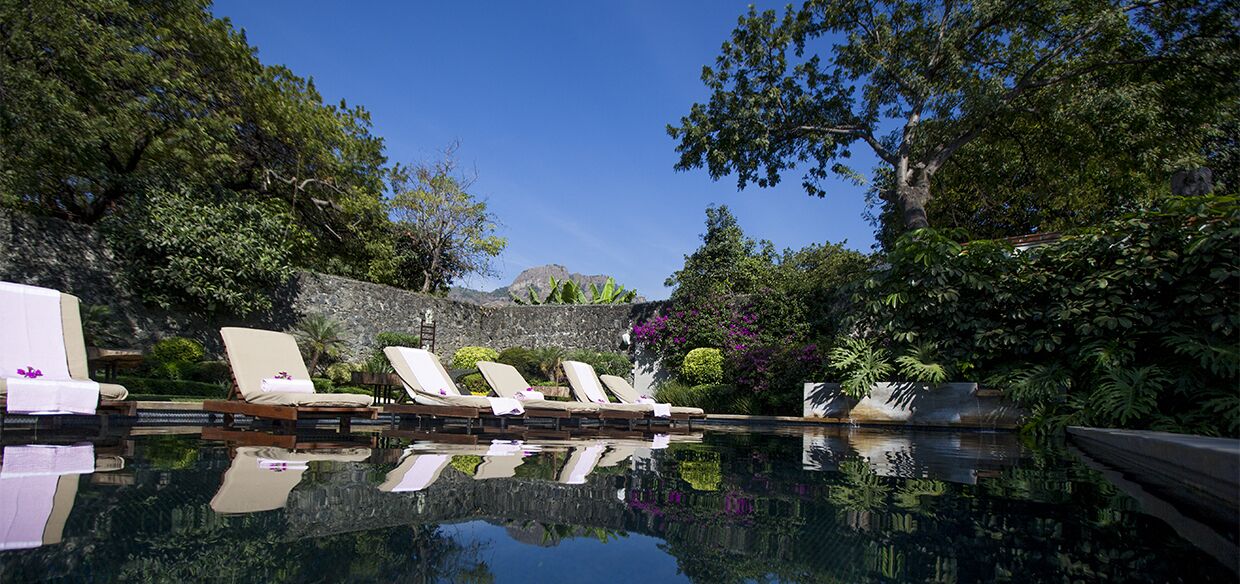 Alberca al aire libre, sombrillas en la alberca y camastros 