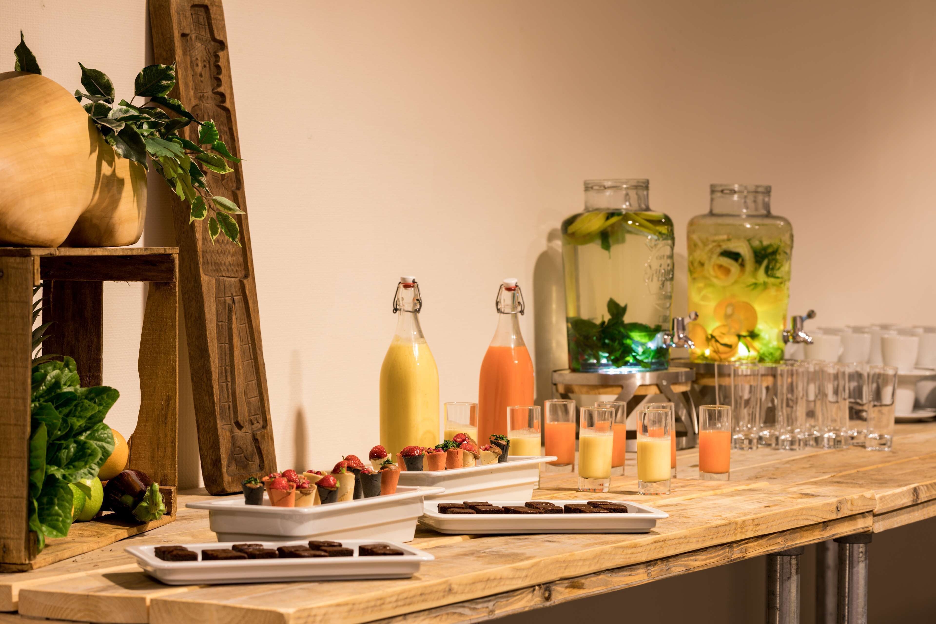 A buffet table with various food items and beverages.