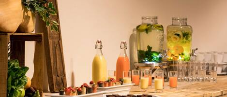 A buffet table with various food items and beverages.