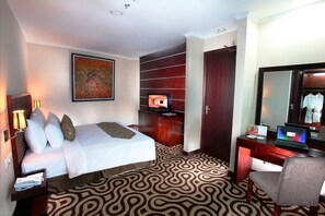 Relax in a stylish room with a comfortable bed, flat-screen TV, and ample workspace.