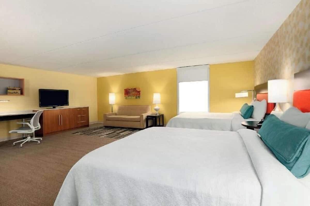 Hypo-allergenic bedding, desk, laptop workspace, blackout drapes