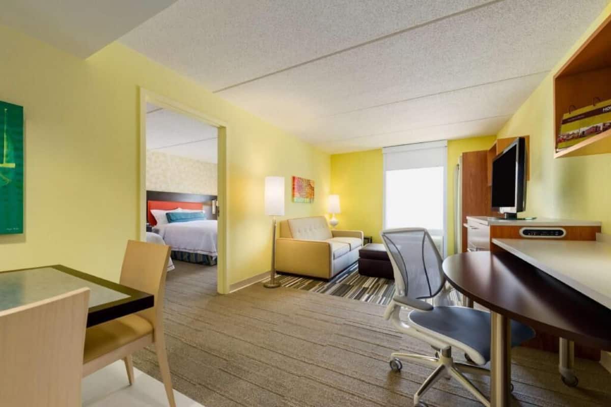 Hypo-allergenic bedding, desk, laptop workspace, blackout drapes