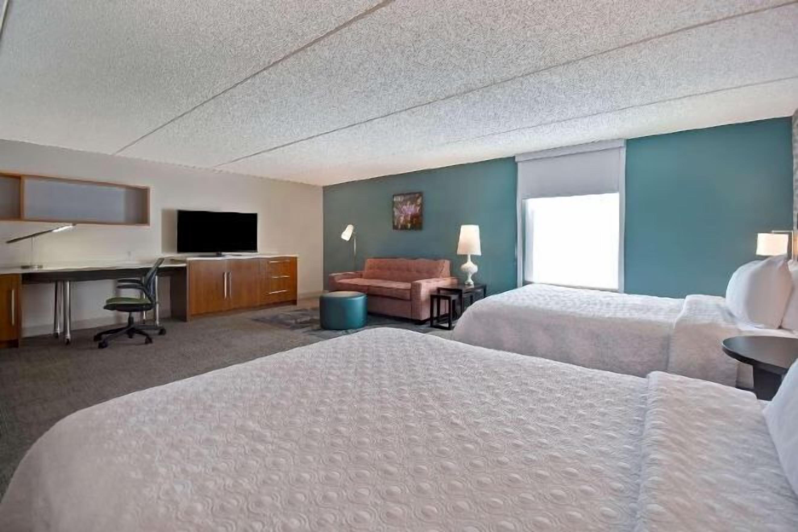 Hypo-allergenic bedding, desk, laptop workspace, blackout drapes