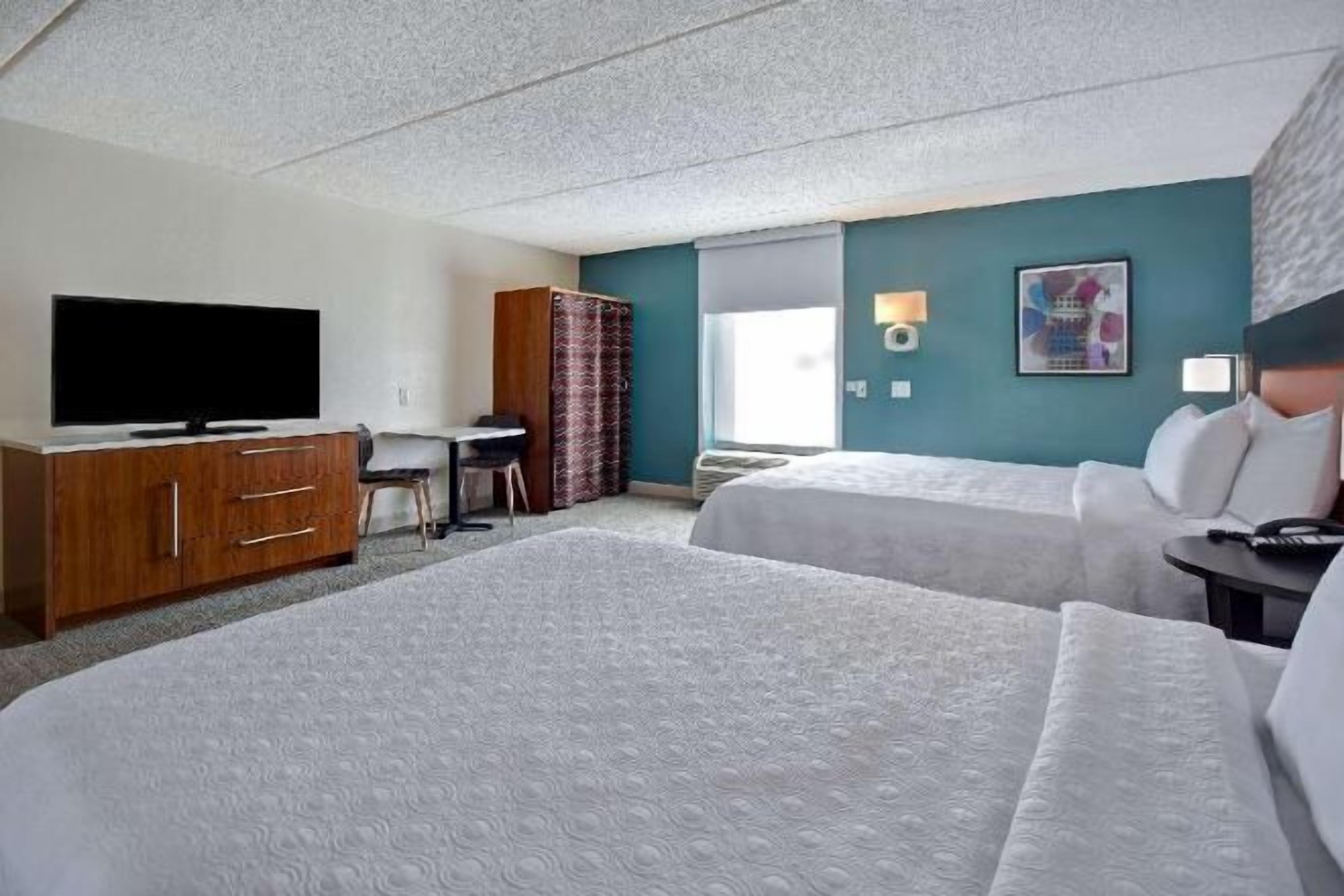 Hypo-allergenic bedding, desk, laptop workspace, blackout curtains