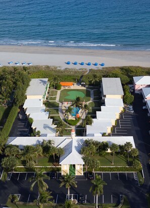 An aerial view of a resort with a pool, parking, and beach access. - Delray Breakers on the Ocean (Delray Beach)