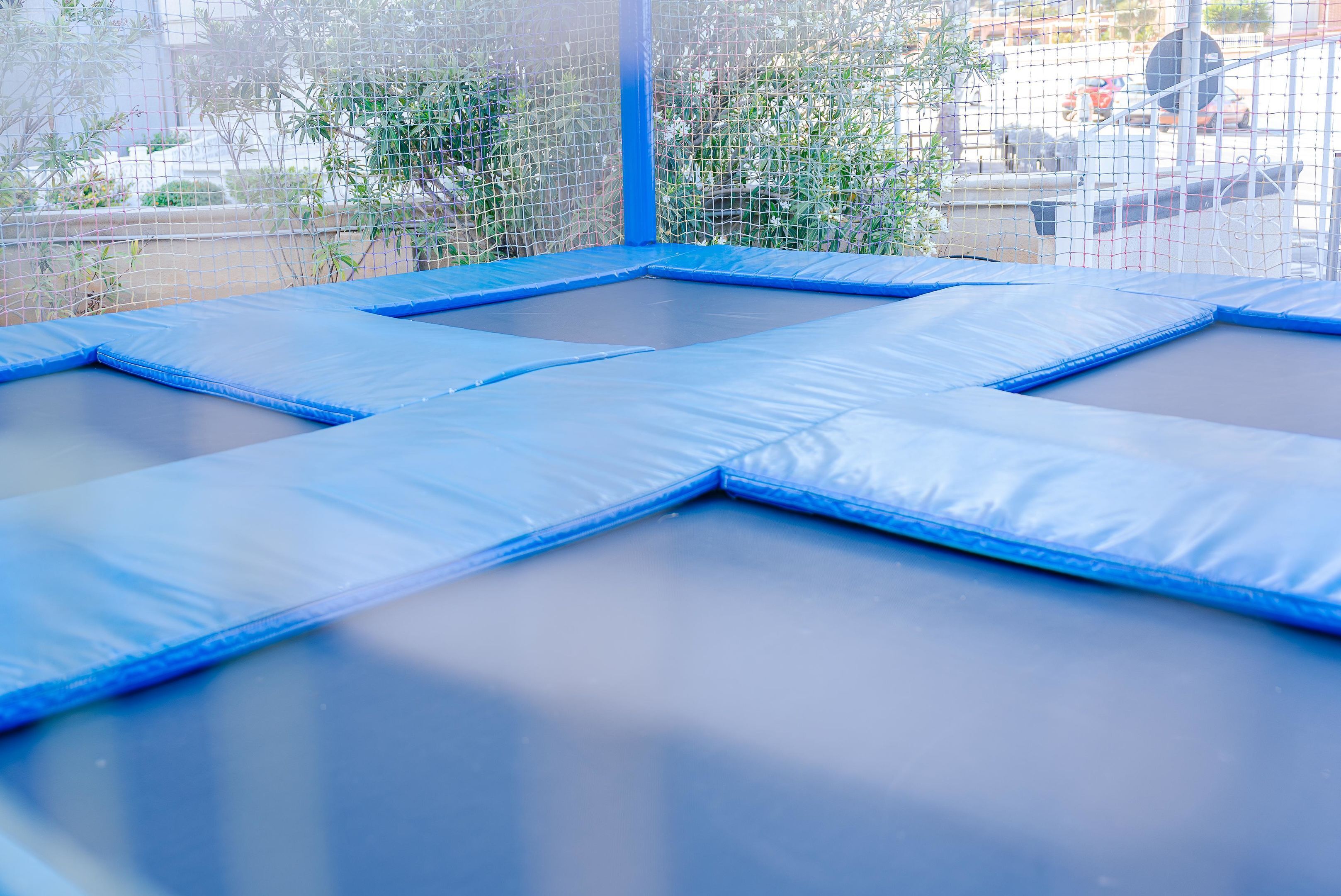 A trampoline with a safety net enclosure.