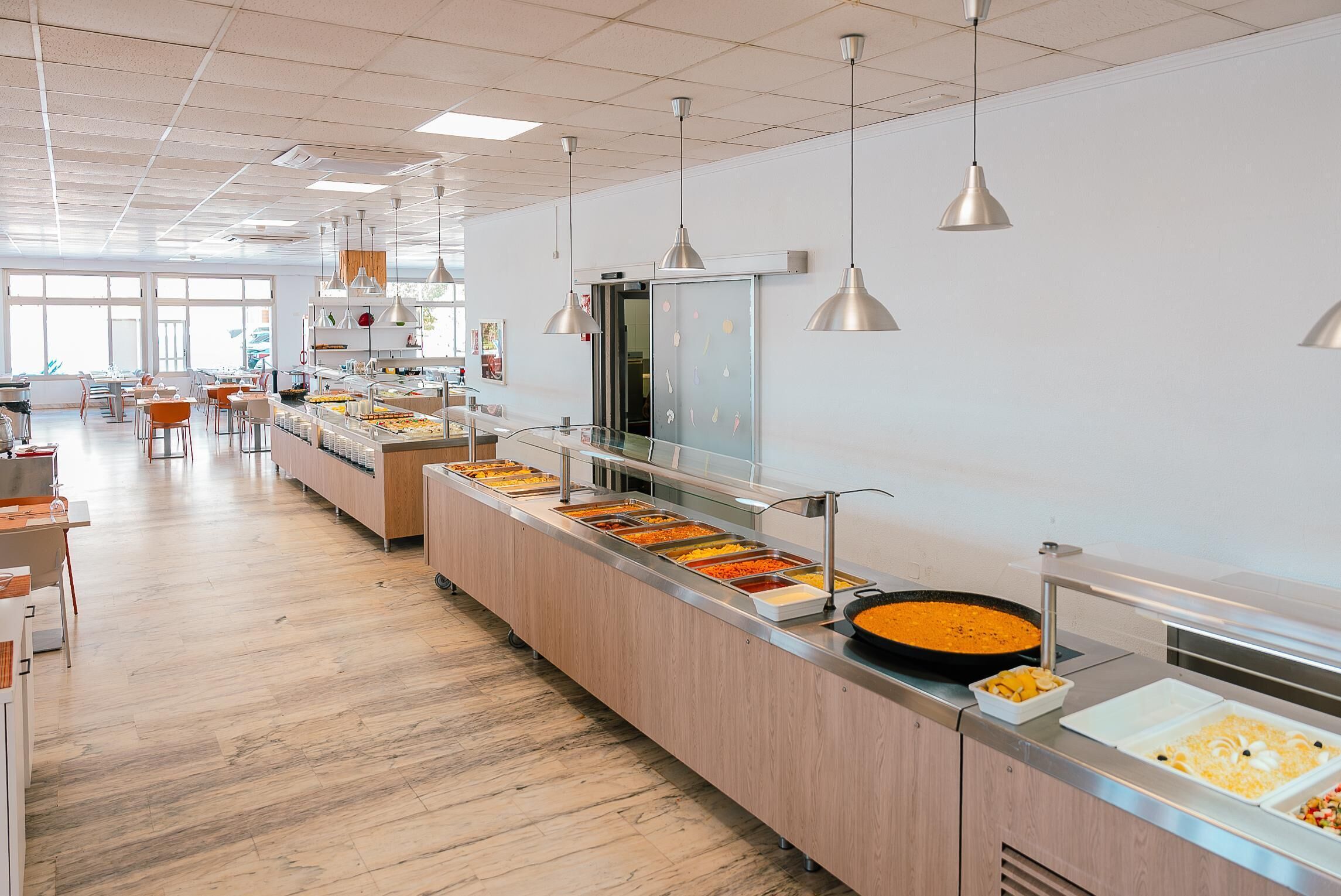 A buffet area with multiple food stations and a long counter.