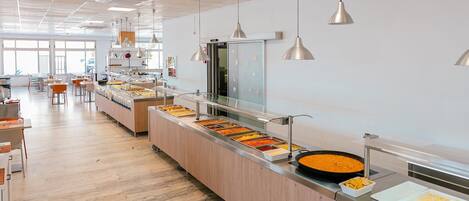 A buffet area with multiple food stations and a long counter.