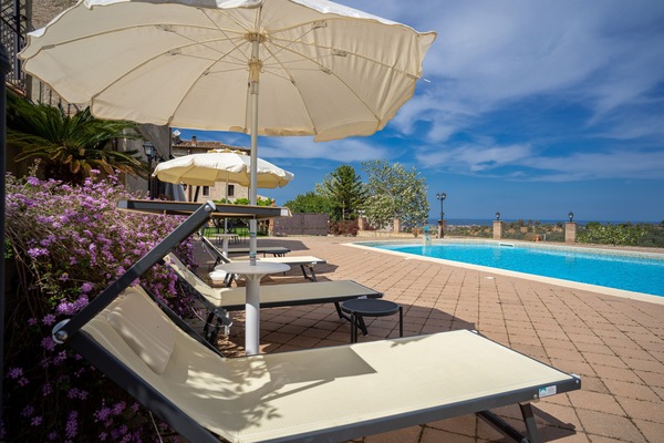 Seasonal outdoor pool, open 8:00 AM to 8:00 PM, pool umbrellas