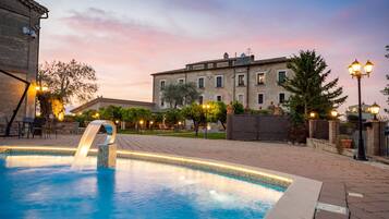 Seasonal outdoor pool, open 8:00 AM to 8:00 PM, pool umbrellas