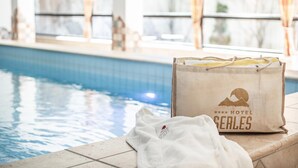 A poolside area with a towel and a hotel bag labeled "HOTEL SEALES" near the pool. - Hotel Serles (Mieders)