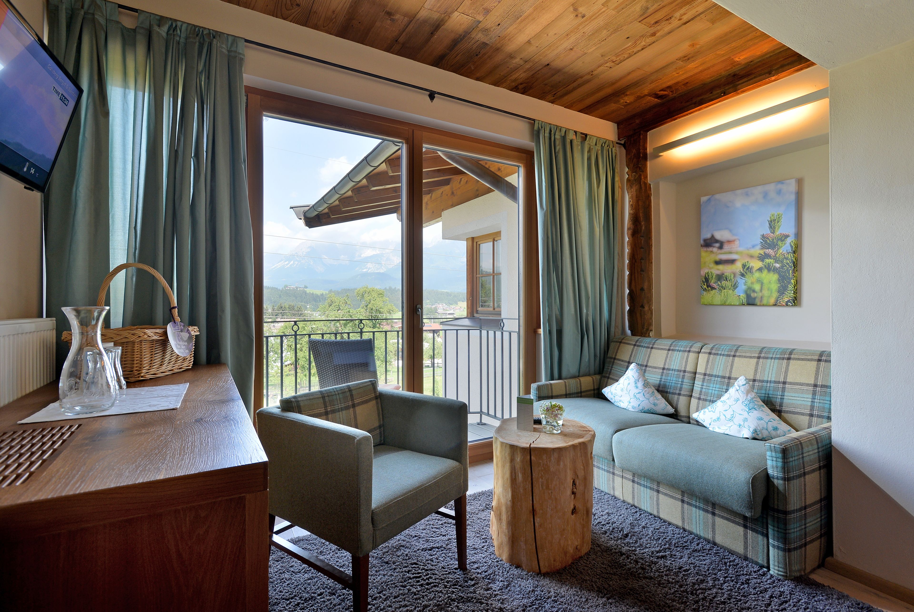 deluxe double room, 1 bedroom, mountain view | living area | flat-screen tv, fireplace, heated floors