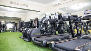 A gym with treadmills, stationary bikes, and weight machines.