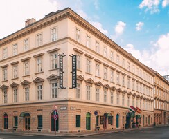 A historic building with multiple windows and a prominent sign for 'Zenith Hotels'.