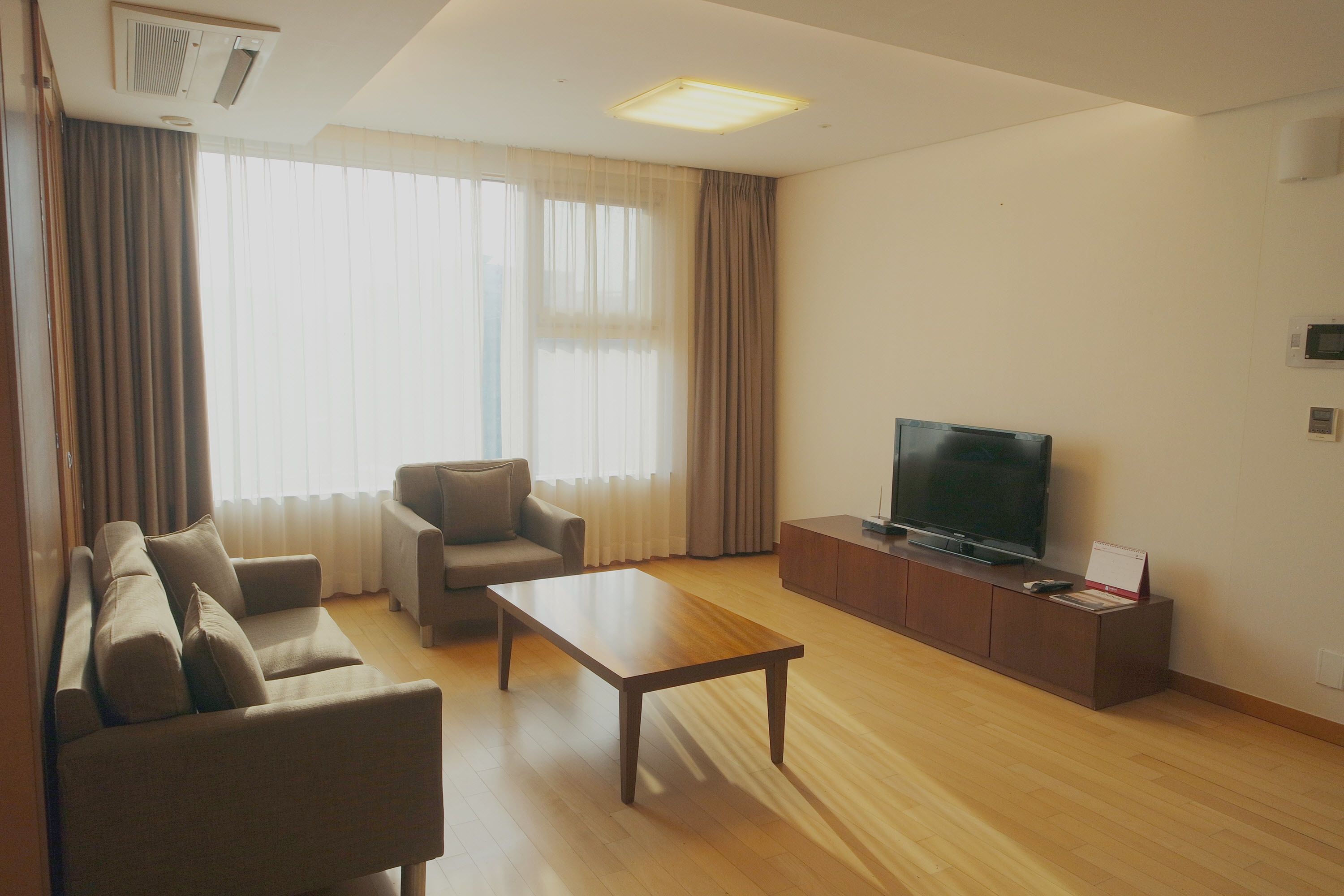 Deluxe Suite, 2 Bedrooms | Living area | Flat-screen TV, DVD player