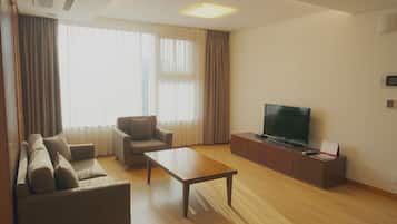 Deluxe Suite, 2 Bedrooms | Living area | Flat-screen TV, DVD player