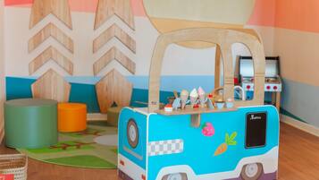 A toy food truck with a handle, wheels, and a menu sign.