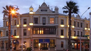 A historic building with a prominent hotel sign, multiple windows, and classic architecture. - The Esplanade Hotel (Auckland)