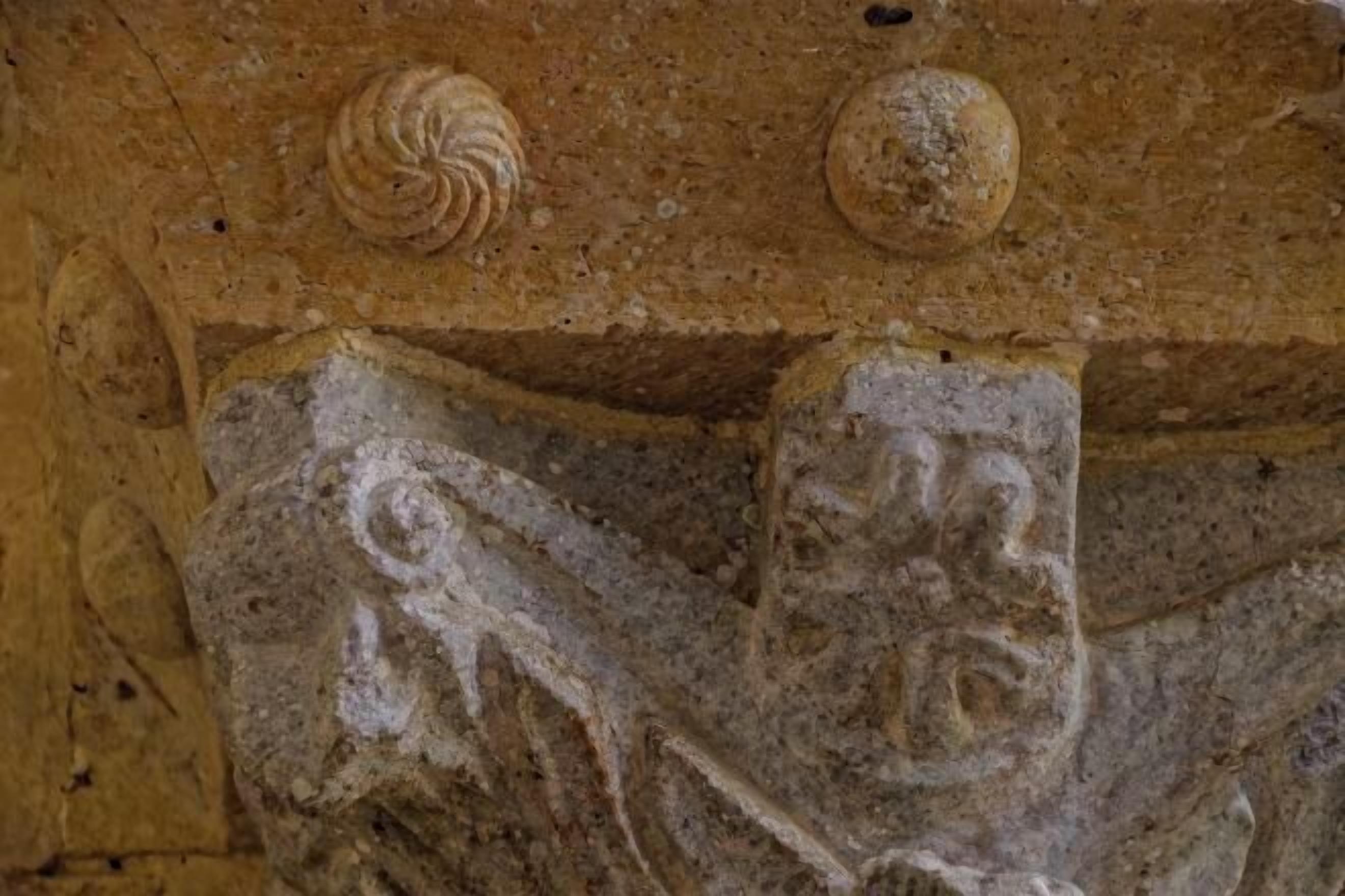 A stone carving with intricate designs, possibly part of a historical building's architecture.