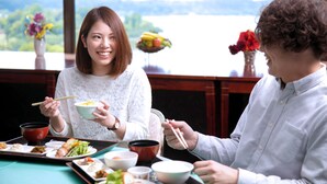 A dining table with various dishes and a scenic view of a lake. - Mito Hotel Season (Mito)