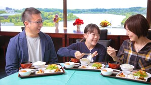 A dining table with various dishes and a scenic view of a lake. - Mito Hotel Season (Mito)