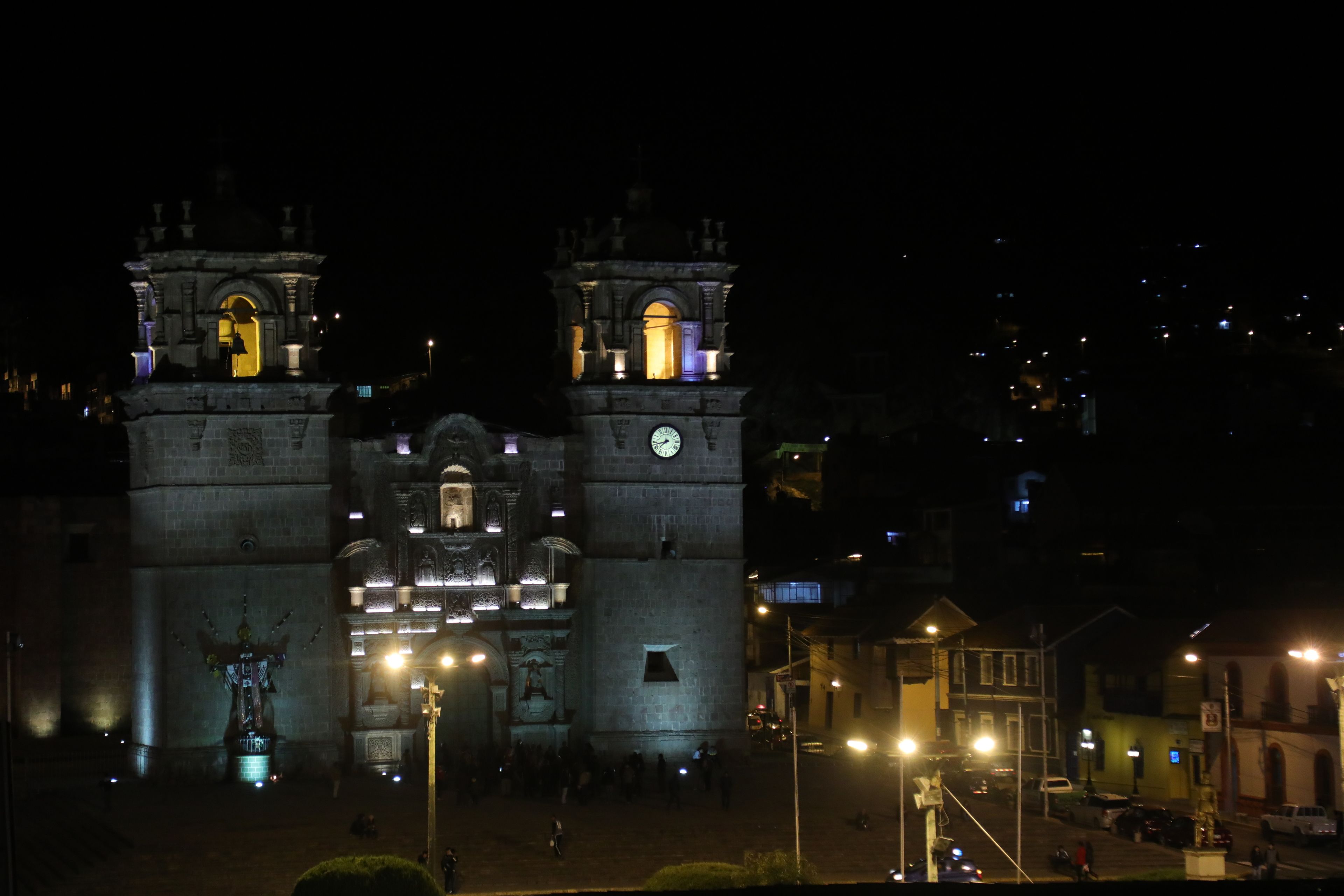 A historic stone building with two towers, a central archway, and a clock.