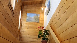 A wooden staircase with a potted plant at the bottom. - Albergo Da Cecilia (Bognanco)