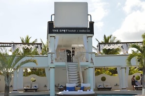 A pool area with a bar named 'The Spot' offering hookah and vodka. - Lifestyle Royal Suites (Puerto Plata)