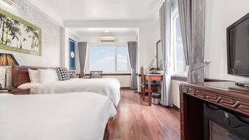 Family Triple Room, 1 Bedroom, City View | Living area | 32-inch Smart TV with cable channels, TV, computer