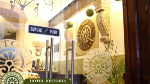 The entrance of Hotel Historia with a sign reading "EMPUJE/PUSH" and a decorative emblem on the wall. - Hotel Historia (Morelia)