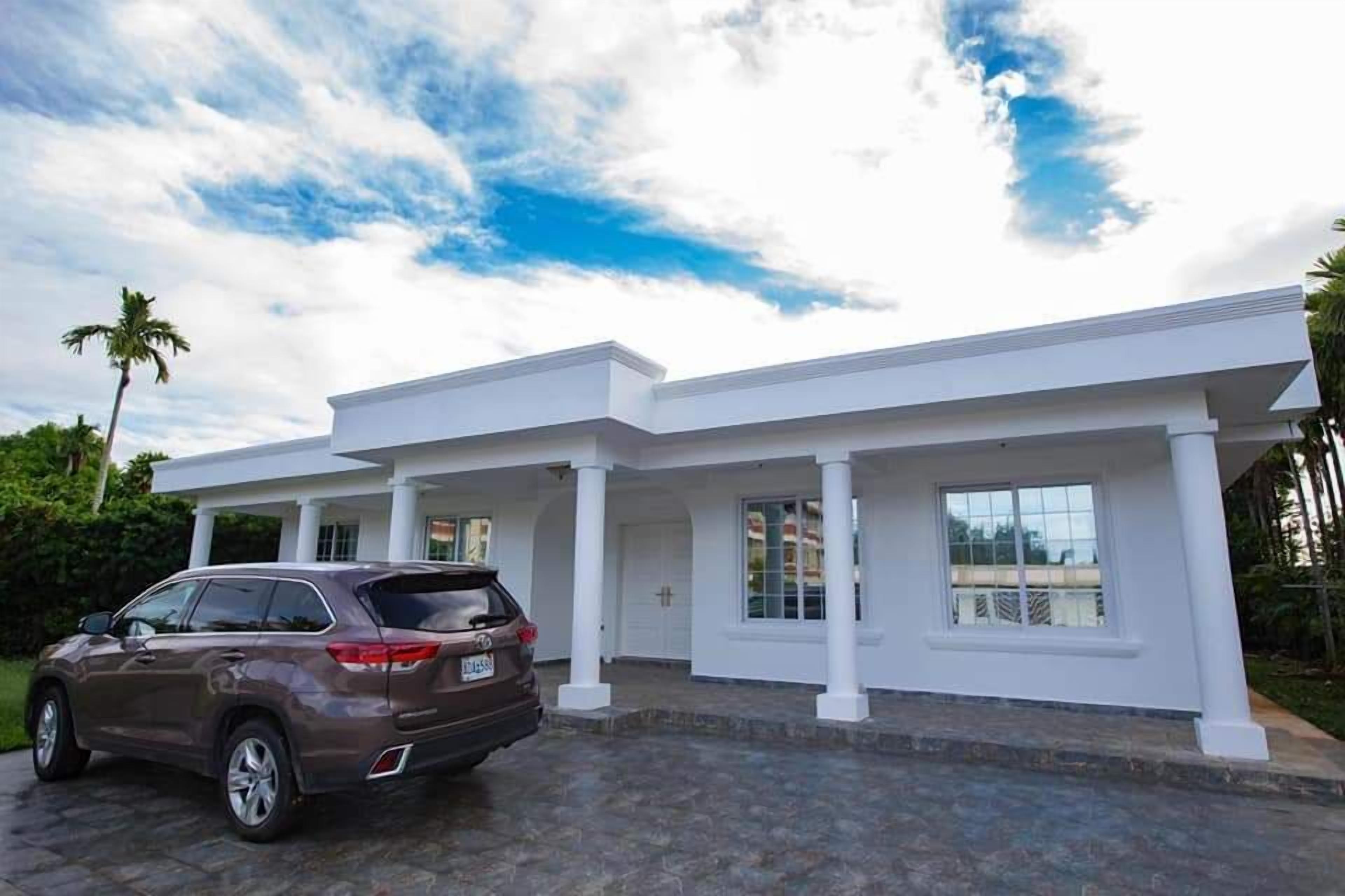 A modern house with a driveway and a parked SUV.