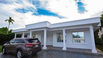 A modern house with a driveway and a parked SUV.